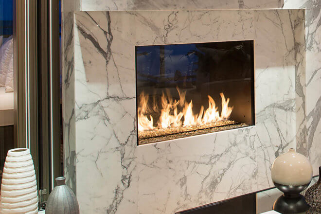 Montigo Exemplar R324STIO fireplace shown between a living room and outdoors