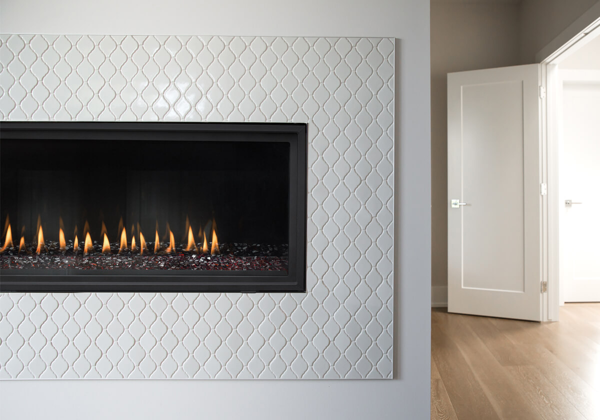 Montigo DelRay Linear DRL3613 fireplace in a white room with custom surround