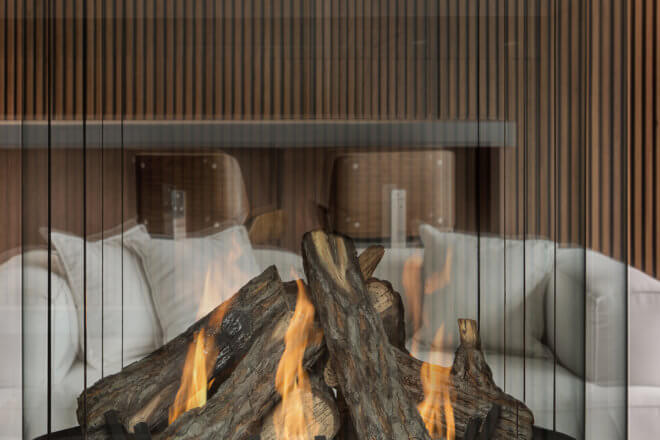 Montigo Mountain Timber custom campfire logset in a round fireplace