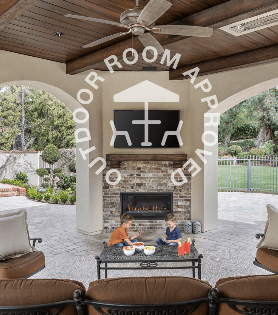 Outdoor Room Approved logo shown with children in front of a fireplace installed outdoors