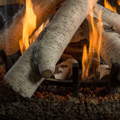 Montigo Birch custom campfire logset in a round fireplace
